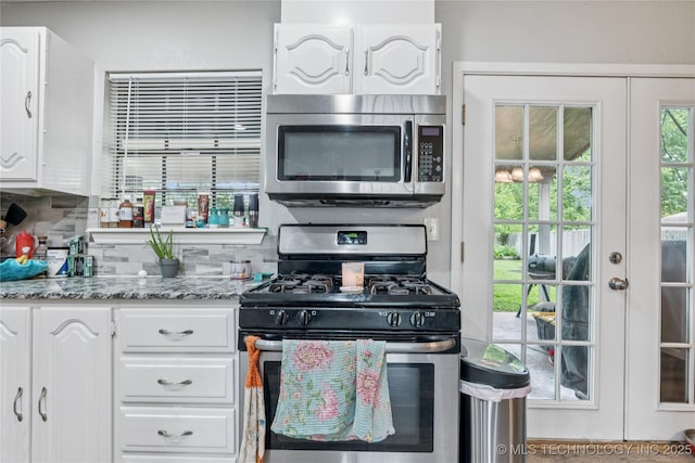 4316 S Ash Ave, Broken Arrow, OK 74011 - kitchen with stainless steel appliances, white cabinets, tasteful backsplash, french doors, and light stone counters