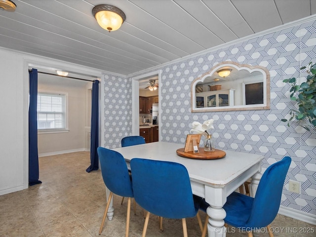 1629 Dewey Ave, Bartlesville, OK 74003 - dining area featuring crown molding, wallpapered walls, and baseboards