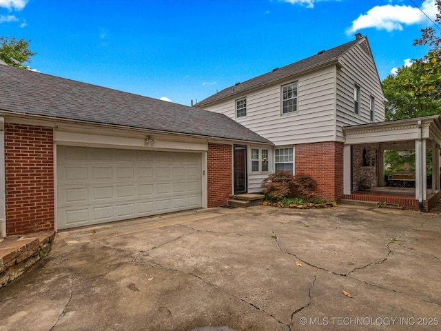 1629 Dewey Ave, Bartlesville, OK 74003 - traditional-style home featuring brick siding, concrete driveway, and a garage