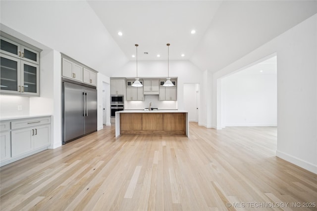 4607 S Retana Pl, Broken Arrow, OK 74011 - kitchen featuring built in appliances, open floor plan, light countertops, vaulted ceiling, and gray cabinetry