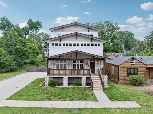 1611 S Lewis Pl, Tulsa, OK 74104 - view of front of house featuring a porch, a front lawn, brick siding, concrete driveway, and stairway