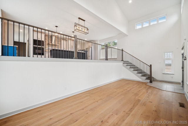 1611 S Lewis Pl, Tulsa, OK 74104 - entryway featuring a high ceiling, wood finished floors, healthy amount of natural light, stairs, and recessed lighting