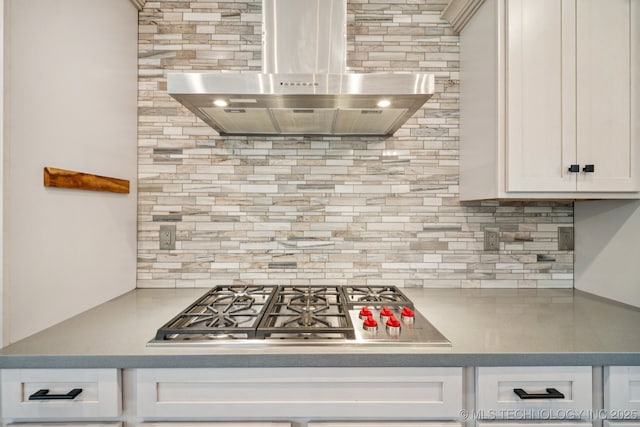 1611 S Lewis Pl, Tulsa, OK 74104 - kitchen featuring exhaust hood, stainless steel gas cooktop, decorative backsplash, and white cabinetry