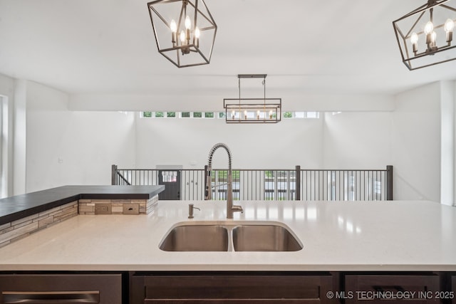 1611 S Lewis Pl, Tulsa, OK 74104 - kitchen featuring a chandelier, dark brown cabinetry, dishwasher, and pendant lighting