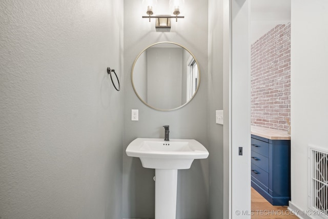 1611 S Lewis Pl, Tulsa, OK 74104 - bathroom featuring wood finished floors and a sink