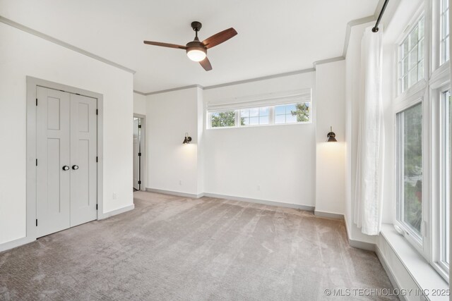 1611 S Lewis Pl, Tulsa, OK 74104 - unfurnished bedroom with carpet flooring, crown molding, and ceiling fan