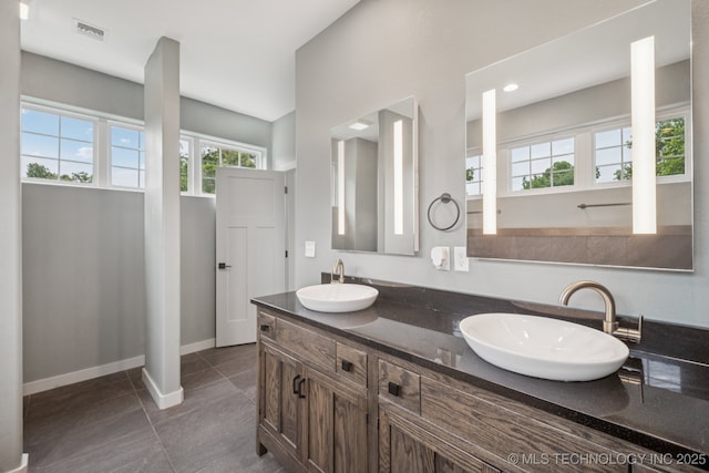 1611 S Lewis Pl, Tulsa, OK 74104 - full bath featuring double vanity and tile patterned flooring