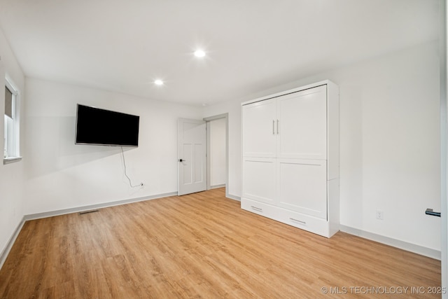 1611 S Lewis Pl, Tulsa, OK 74104 - unfurnished bedroom with light wood-type flooring, recessed lighting, and a closet