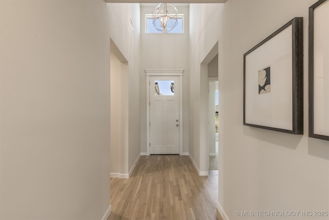 5109 S Everett Dr, Sand Springs, OK 74063 - entryway featuring a chandelier, light wood-style floors, plenty of natural light, baseboards, and a high ceiling