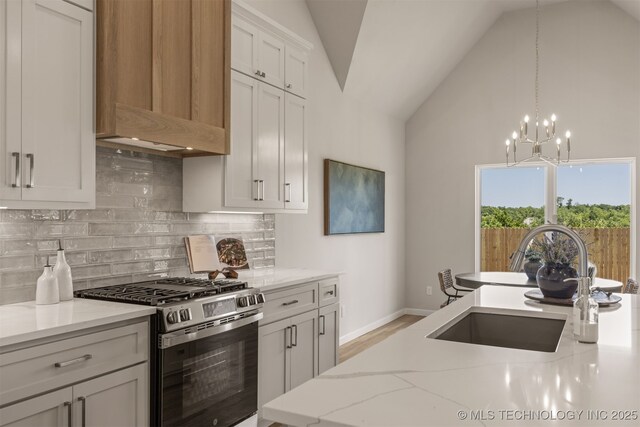 5109 S Everett Dr, Sand Springs, OK 74063 - kitchen featuring gas range, a sink, custom range hood, vaulted ceiling, and tasteful backsplash