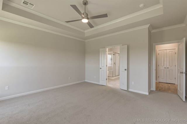 5109 S Everett Dr, Sand Springs, OK 74063 - unfurnished bedroom featuring a raised ceiling, light colored carpet, baseboards, crown molding, and connected bathroom