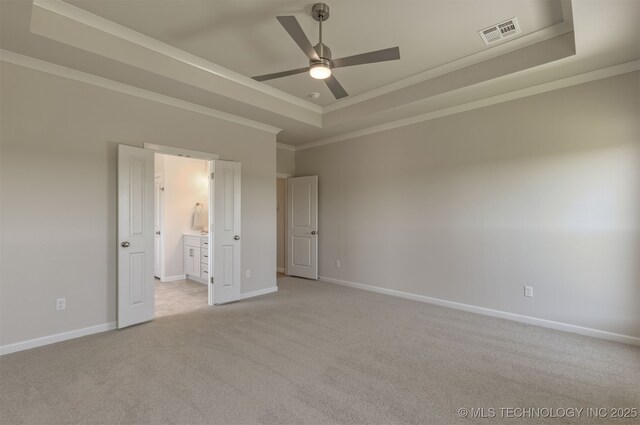 5109 S Everett Dr, Sand Springs, OK 74063 - unfurnished bedroom featuring a raised ceiling, crown molding, light carpet, baseboards, and ensuite bath