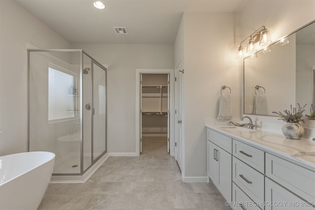5109 S Everett Dr, Sand Springs, OK 74063 - full bath featuring a shower stall, double vanity, a walk in closet, a freestanding bath, and baseboards
