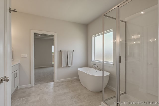 5109 S Everett Dr, Sand Springs, OK 74063 - bathroom with vanity, a freestanding bath, a stall shower, and baseboards