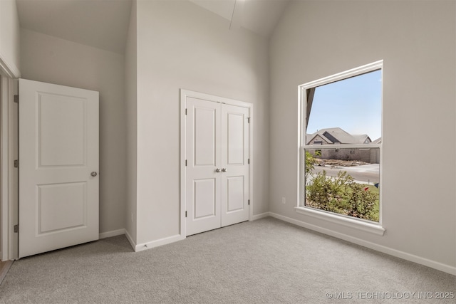 5109 S Everett Dr, Sand Springs, OK 74063 - unfurnished bedroom featuring carpet, baseboards, high vaulted ceiling, and a closet