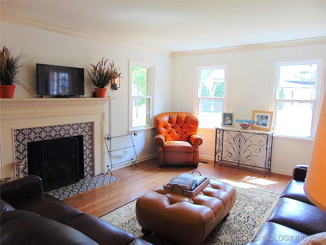 2619 E 47th St, Tulsa, OK 74105 - living room featuring wood finished floors, crown molding, baseboards, and a fireplace with flush hearth