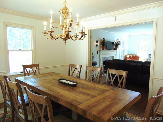 2619 E 47th St, Tulsa, OK 74105 - dining area featuring a chandelier, a fireplace, and ornamental molding