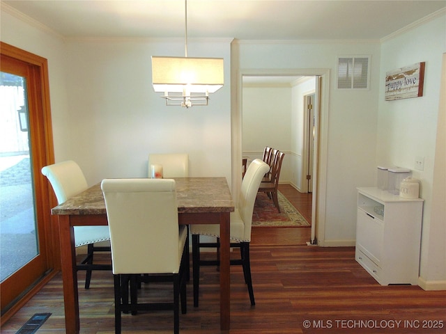 2619 E 47th St, Tulsa, OK 74105 - dining area featuring ornamental molding, dark wood finished floors, a chandelier, and baseboards