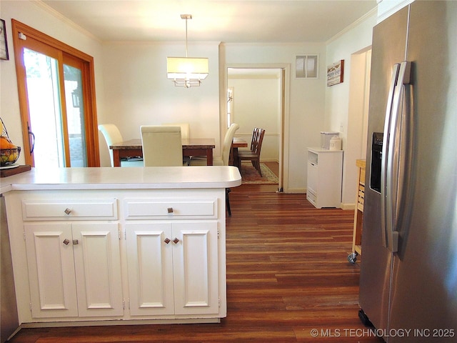 2619 E 47th St, Tulsa, OK 74105 - kitchen with stainless steel fridge, a peninsula, crown molding, dark wood finished floors, and white cabinets