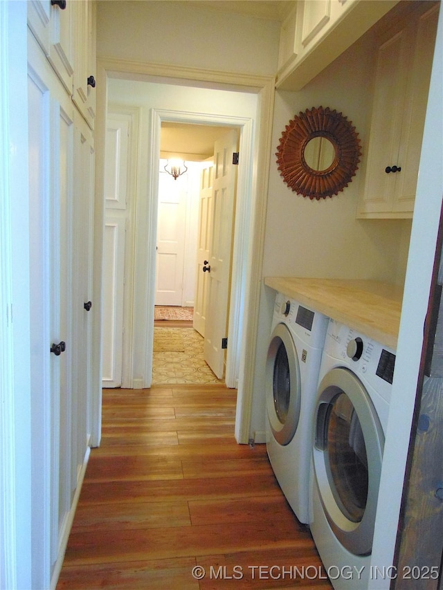 2619 E 47th St, Tulsa, OK 74105 - laundry room with washer and dryer, cabinet space, and wood finished floors