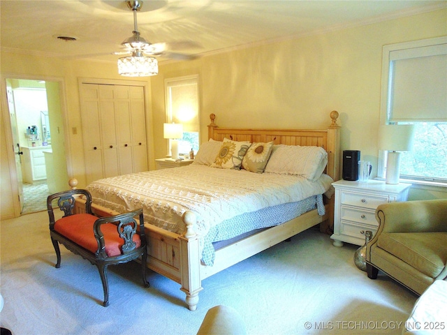 2619 E 47th St, Tulsa, OK 74105 - bedroom featuring light carpet, ornamental molding, a closet, and ceiling fan