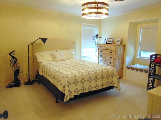 2619 E 47th St, Tulsa, OK 74105 - bedroom featuring ornamental molding, light carpet, and a chandelier
