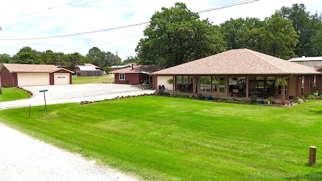 421224 E 1165th Rd, Eufaula, OK 74432 - view of green lawn with gravel driveway, a garage, and an outbuilding