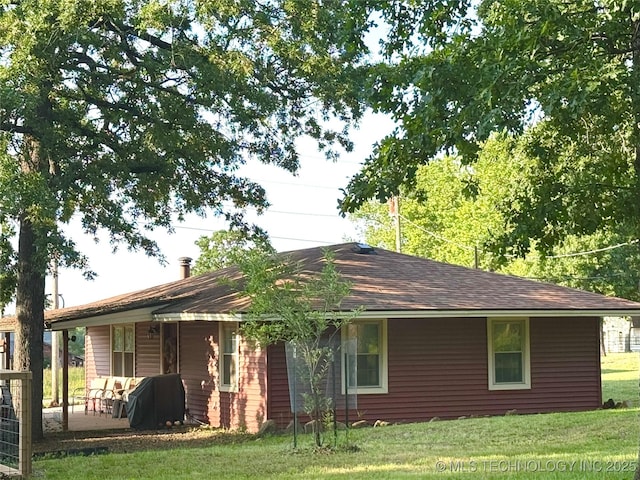 421224 E 1165th Rd, Eufaula, OK 74432 - rear view of house with a lawn and a shingled roof
