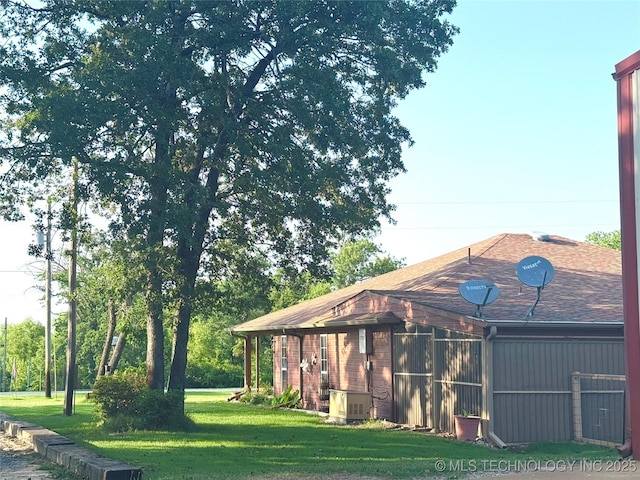 421224 E 1165th Rd, Eufaula, OK 74432 - back of house with a yard and roof with shingles