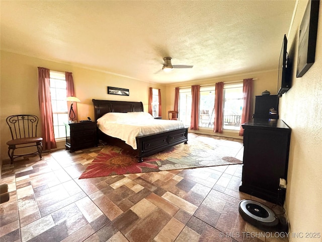 421224 E 1165th Rd, Eufaula, OK 74432 - bedroom featuring multiple windows, a textured ceiling, stone tile flooring, and a ceiling fan