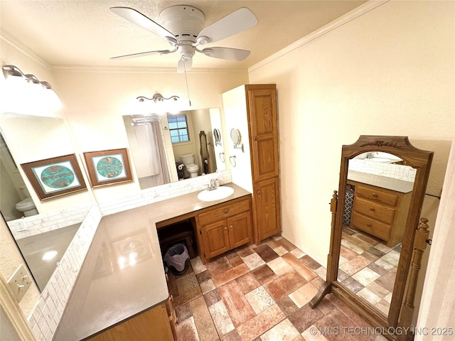 421224 E 1165th Rd, Eufaula, OK 74432 - bathroom with toilet, stone finish floors, ornamental molding, ceiling fan, and vanity
