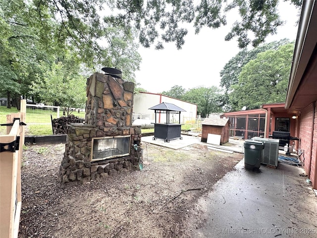 421224 E 1165th Rd, Eufaula, OK 74432 - view of yard with an outdoor stone fireplace and a patio