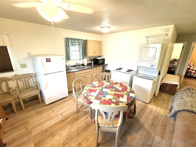 421224 E 1165th Rd, Eufaula, OK 74432 - kitchen featuring freestanding refrigerator, black microwave, light wood-type flooring, a sink, and a textured ceiling