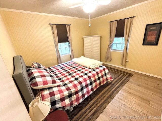 421224 E 1165th Rd, Eufaula, OK 74432 - bedroom featuring wood finished floors, ornamental molding, a textured ceiling, ceiling fan, and baseboards
