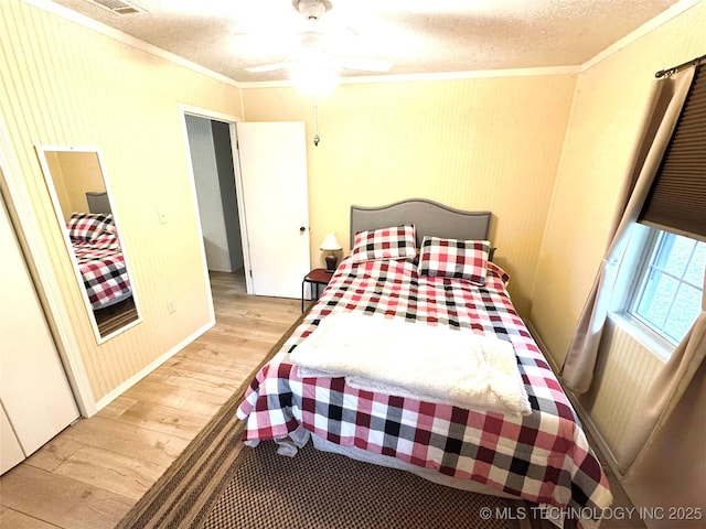 421224 E 1165th Rd, Eufaula, OK 74432 - bedroom with ornamental molding, light wood-style floors, and a textured ceiling