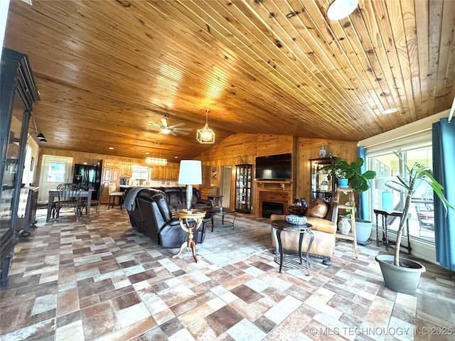 421224 E 1165th Rd, Eufaula, OK 74432 - living room featuring vaulted ceiling, wooden walls, wood ceiling, a large fireplace, and a ceiling fan