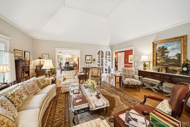 4817 S Yorktown Pl, Tulsa, OK 74105 - living area featuring wood finished floors, a chandelier, vaulted ceiling, and ornamental molding