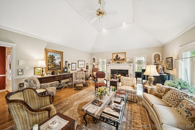 4817 S Yorktown Pl, Tulsa, OK 74105 - living area featuring wood finished floors, lofted ceiling, a ceiling fan, a warm lit fireplace, and crown molding