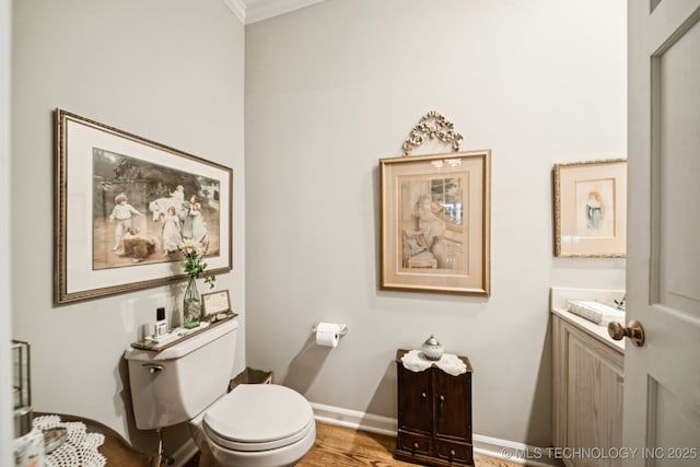 4817 S Yorktown Pl, Tulsa, OK 74105 - half bathroom with toilet, vanity, ornamental molding, baseboards, and wood finished floors