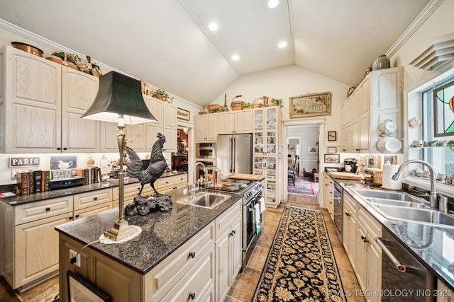 4817 S Yorktown Pl, Tulsa, OK 74105 - kitchen with stainless steel appliances, a sink, an island with sink, glass insert cabinets, and recessed lighting