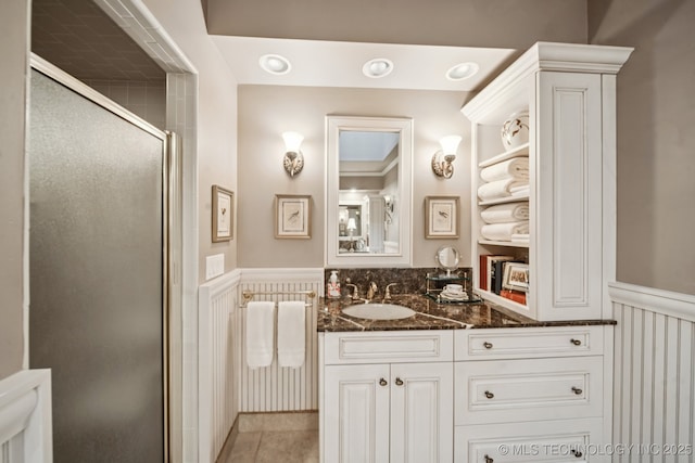 4817 S Yorktown Pl, Tulsa, OK 74105 - full bathroom with vanity, a stall shower, tile patterned floors, and a wainscoted wall