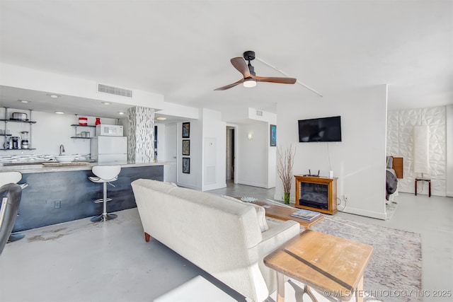 450 W 7th St Unit 1405, Tulsa, OK 74119 - living room featuring finished concrete floors and ceiling fan