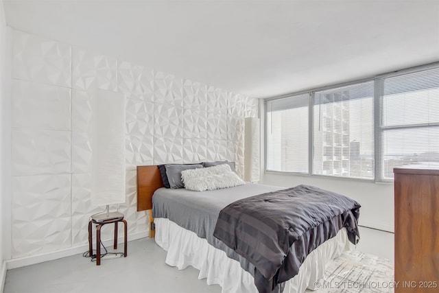 450 W 7th St Unit 1405, Tulsa, OK 74119 - bedroom featuring finished concrete flooring and baseboards