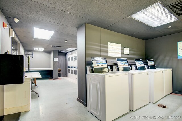450 W 7th St Unit 1405, Tulsa, OK 74119 - community laundry room featuring washer and dryer and baseboards