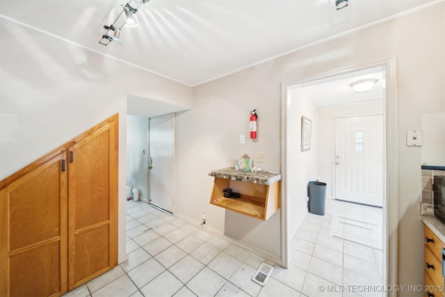 1525 N College Ave, Tulsa, OK 74110 - entryway with light tile patterned floors, rail lighting, and baseboards