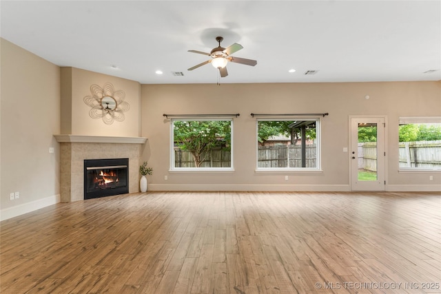 4675 E 144th Pl S, Bixby, OK 74008 - unfurnished living room with wood finished floors, a fireplace, plenty of natural light, ceiling fan, and recessed lighting