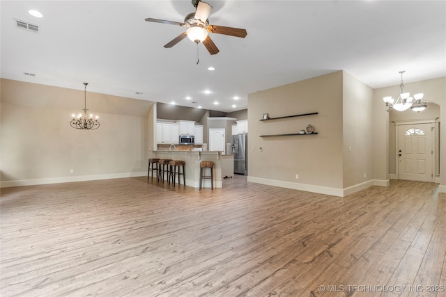 4675 E 144th Pl S, Bixby, OK 74008 - living area featuring a chandelier, light wood finished floors, ceiling fan, baseboards, and recessed lighting