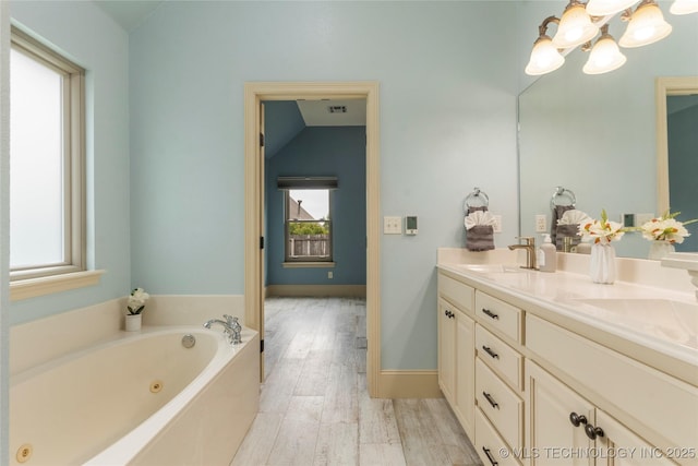 4675 E 144th Pl S, Bixby, OK 74008 - bathroom featuring double vanity, a chandelier, a jetted tub, and wood finished floors
