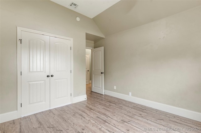 4675 E 144th Pl S, Bixby, OK 74008 - unfurnished bedroom with vaulted ceiling, wood finished floors, a closet, and baseboards