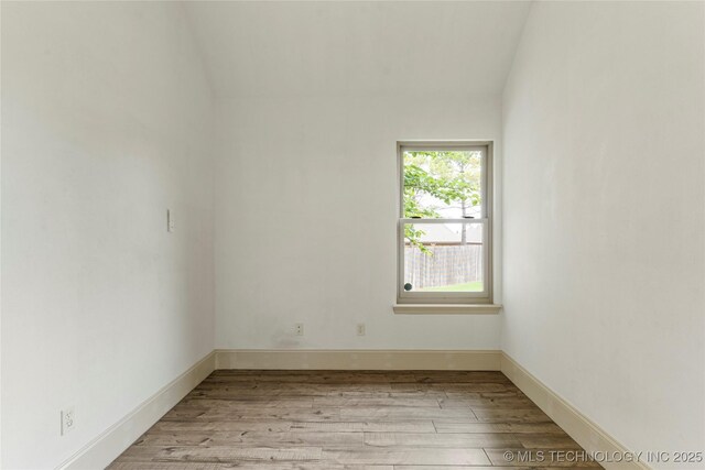 4675 E 144th Pl S, Bixby, OK 74008 - empty room featuring light wood finished floors and vaulted ceiling